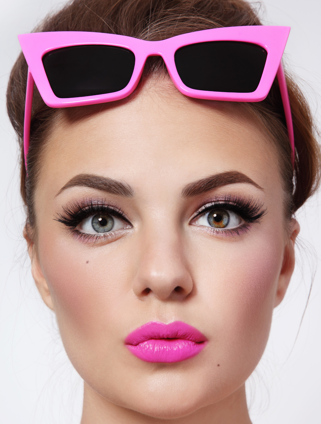 Portrait of young beautiful woman with pink lipstick and stylish vintage sunglasses