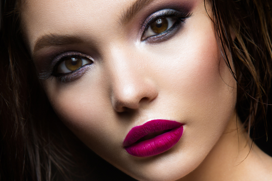 Beautiful young model with pink lips and dark makeap
